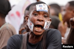 A supporter of Congolese political veteran and presidential candidate Martin Fayulu, reacts during Fayulu's final campaign rally in Kinshasa, the Democratic Republic of Congo, Dec.16, 2023.