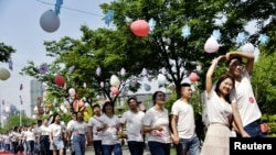 FILE - Couples attend a mass wedding ceremony in Rugao, Jiangsu province, China May 20, 2020. 
