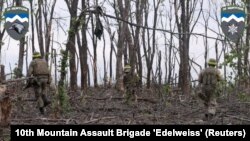 Ukrainian servicemen of the 10th Mountain Assault Brigade 'Edelweiss' fight near Bakhmut, in the Donetsk region of Ukraine, in this screen grab from a social media video released May 19, 2023. (10th Mountain Assault Brigade 'Edelweiss'/via Reuters)