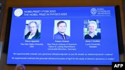 (L-R) US-based physicist Pierre Agostini, Hungarian-Austrian physicist Ferenc Krausz, and French physicist Anne L'Huillier appear on the screen during the announcement of the winners of the 2023 Nobel Prize in Physics in Stockholm on Oct. 3, 2023. 