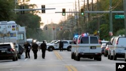 Law enforcement officers investigate the scene of a mass shooting at a Dollar General store, Aug. 26, 2023, in Jacksonville, Flrida.