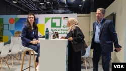 Officials from Palestinian territories gather inside the Palestine pavilion at COP28 in Dubai, UAE, on Dec. 3, 2023. (Bilal Hussain/VOA)