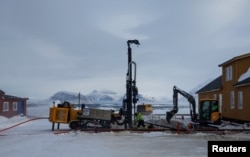 Kings Bay AS contractors replace the foundation of Butikken building, the town store, after it was damaged by thawing permafrost in Ny-Aalesund, Svalbard, April 5, 2023.