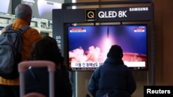 FILE - People watch a TV broadcasting a news report on North Korea firing a ballistic missile into the sea off its east coast, at a railway station in Seoul, South Korea, March 16, 2023.
