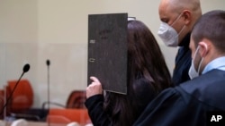 FILE - Defendant Jennifer W. arrives for trial in a courtroom in Munich, Germany, Oct. 25, 2021. On March 9, 2023, an appeals court ordered a new sentencing hearing for her on charges she allowed a 5-year-old girl she and her husband kept as a slave to die of thirst in the sun. 