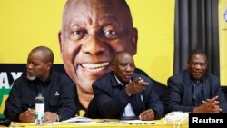 South African President Cyril Ramaphosa gestures next to members of the National Executive Committee (NEC), Deputy President Paul Mashatile and Gwede Mantashe, as they meet to look at options to form a new government, in Boksburg, June 6, 2024. 
