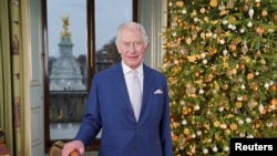 Britain's King Charles poses for a photo during the recording of his Christmas message at Buckingham Palace, in London, Dec. 7, 2023. (Jonathan Brady/Pool via Reuters) 