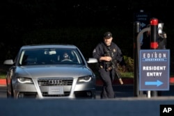 Cobb County Police search cars as they leave the Edison Apartments in Smyrna, Georgia, May 3, 2023, after a shooter killed one person and injured four others in a medical building in Atlanta, then was seen on a traffic camera in the area.