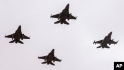FILE - F16 fighter jets perform a maneuver as part of the African Lion military exercise, over Tantan, south of Agadir, Morocco, May 31, 2024.