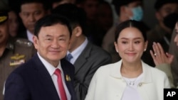 FILE - Thailand's former Prime Minister Thaksin Shinawatra, with his daughter Paetongtarn, arrives at Don Muang airport in Bangkok, Aug. 22, 2023. Paetongtarn Shinawatra. On Sunday she formally became Thailand's 31st prime minister.