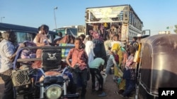 FILE - People displaced by the conflict in Sudan flee Wad Madani, the capital of al-Jazirah state, heading to Gadaref state on Dec. 16, 2023. 