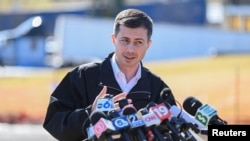 U.S. Transportation Secretary Pete Buttigieg speaks as he visits the site of the derailment of a train carrying hazardous waste in East Palestine, Ohio, Feb. 23, 2023. 