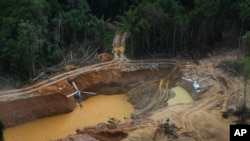 FILE - A Brazil Environmental Agency helicopter flies over an illegal mining camp during an operation to try to contain it in Yanomami Indigenous territory, Roraima state, Brazil, Feb. 11, 2023. 