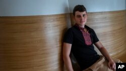 Drawings by Mykola Kostenko are part of the War Diaries exhibition, showcasing the personal diaries of Ukrainian children who have witnessed the war, hosted by Amsterdam city hall, Netherlands, Aug. 17, 2023. 