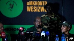 Former South African President Jacob Zuma speaks as his daughter Duduzile Zuma-Sambudla listens, during a press conference in Soweto, South Africa, Dec. 16, 2023. 