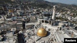 FILE - The remains of a mosque in the aftermath of a deadly earthquake in Idlib province, Syria, Feb. 24, 2023. Sources say Iran has used earthquake relief flights to bring weapons and military equipment into its strategic ally Syria.