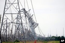 Fallen power lines are shown in the aftermath of a severe thunderstorm in Cypress, Texas, near Houston, May 17, 2024.
