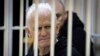 FILE - Ales Bialiatski, the head of Belarusian Vyasna rights group, sits in a defendants' cage during a court session in Minsk, Belarus, on Thursday Jan. 5, 2023. 