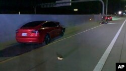 FILE - This photo provided by Utah Department of Public Safety shows the scene of an accident involving a Tesla and a motorcycle, July 24, 2022 near Draper, Utah. Two crashes involving Teslas apparently running on Autopilot are drawing scrutiny from federal regulators.
