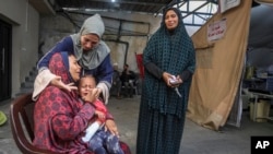 Palestinians mourn their relatives killed in the Israeli bombardment of the Gaza Strip, at a hospital in Rafah, Gaza, May 10, 2024.