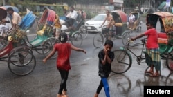 Children cool themselves in the water, sprayed from a spray cannon by Dhaka North City Corporation, during a countrywide heatwave in Dhaka, Bangladesh, April 28, 2024. 