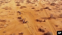 FILE - People arrive at a displacement camp on the outskirts of Dollow, Somalia, Sept. 21, 2022 amid a drought. 