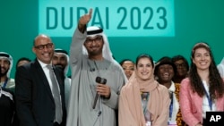 From left, U.N. Climate Chief Simon Stiell, COP28 President Sultan al-Jaber and chief COP28 negotiator for the United Arab Emirates Hana Al-Hashimi pose for a photo at the end of the COP28 U.N. Climate Summit in Dubai, UAE, Dec. 13, 2023.