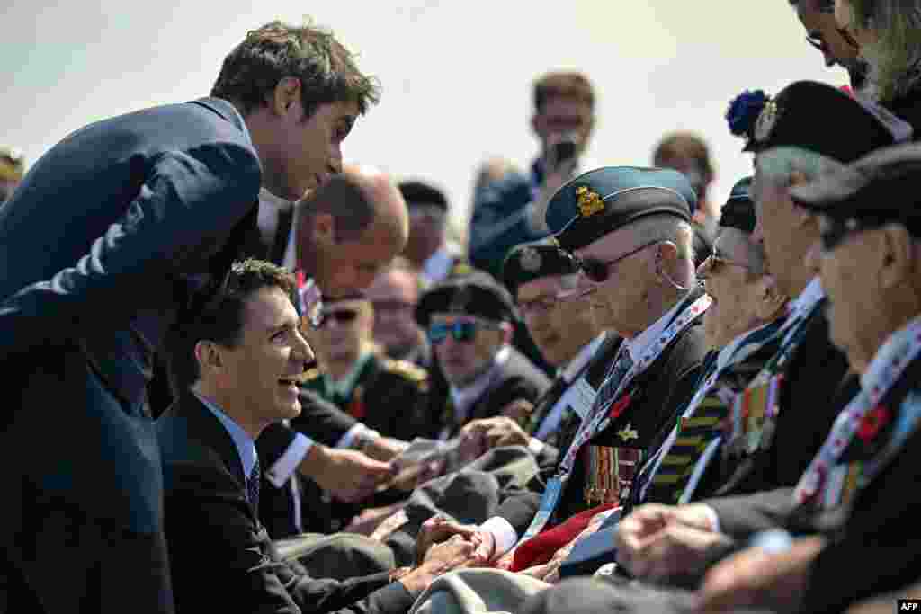 France's Prime Minister Gabriel Attal (L), Canadian Prime Minister Justin Trudeau (C) and Prince Britain's Prince William, the Prince of Wales (L) speak with WWII veterans during the Canadian commemorative ceremony marking the 80th anniversary of the World War II "D-Day" Allied landings in Normandy, at the Juno Beach Centre near the village of Courseulles-sur-Mer, in northwestern France, June 6, 2024.&nbsp;