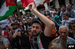 A man shouts slogans during a protest against Israel's military offensive in the Gaza Strip in front of the United Nations Program for Development office in Caracas, Oct. 21, 2023.
