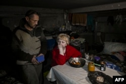Local residents take shelter and live in a basement in the village of Chasiv Yar, near the city of Bakhmut in the region of Donbas, March 5, 2023