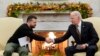 President Joe Biden, right, shakes hands with Ukrainian President Volodymyr Zelenskyy as they meet in the Oval Office of the White House, in Washington, Dec. 12, 2023.