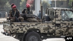 FILE - Security forces ride on the back of a pick-up truck in Addis Ababa, Ethiopia, June 5, 2022. Ethiopian authorities have arrested three journalists since introducing a new state of emergency in August.