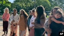 Supporters of a lawsuit challenging a Hawaii midwife licensure law gather outside a courthouse in Honolulu on June 10, 2024. 