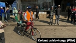 Ngoni Nyamadzawo, a part-time gardener in Harare’s affluent suburbs, cycles June 1, 2024. He bikes daily as a way to reduce costs to save his salary.