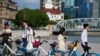 FILE - Couples prepare to get their photo taken during a wedding photography shoot on a street, in Shanghai, China Sept. 6, 2023.