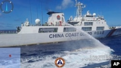 FILE - In this photo provided by the Philippine Coast Guard, a Chinese coast guard ship uses water canons on a Philippine Coast Guard ship near the Philippine-occupied Second Thomas Shoal, South China Sea during a re-supply mission on Aug. 5, 2023.