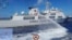 FILE - In this photo provided by the Philippine coast guard, a Chinese coast guard ship uses water canons on a Philippine coast guard ship near the Philippine-occupied Second Thomas Shoal, in the South China Sea, during a resupply mission on Aug. 5, 2023.