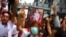 FILE - Protesters hold up a portrait of Aung San Suu Kyi and raise three-finger salutes, during a demonstration to mark the second anniversary of Myanmar's 2021 military coup, outside the Embassy of Myanmar in Bangkok, Thailand, Feb. 1, 2023.