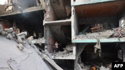 Palestinians children search through the rubble of their home a day after an operation by the Israeli Special Forces in the Nuseirat camp, in the central Gaza Strip on June 9, 2024.