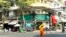 A monk walks in front of a branch office of Amret Microfinance Institution in Daun Penh district, Phnom Penh, Cambodia’s capital, April 5, 2024. (Sun Narin/VOA Khmer)