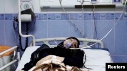 A young woman lies in hospital after reports of poisoning at an unspecified location in Iran in this still image from video from March 2, 2023. (WANA/Reuters TV via Reuters)