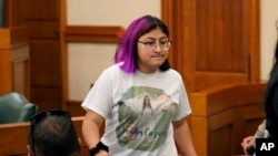FILE - Jazmin Cazares, whose young sister Jackie was was one of 19 children killed at Robb Elementary School in Uvalde, Texas, attends a hearing, June 23, 2022, in Austin, Texas. Cazares will be among invited guests at President Joe Biden's State of the Union address.
