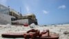 An abandoned shoe lies at the scene of an explosion that occurred while revelers were swimming at the Lido beach in Mogadishu, Somalia, Aug. 3, 2024. 
