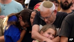 Family members mourn during the funeral of Israeli soldier Shilo Rauchberger at the Mount Herzl cemetery in Jerusalem, Oct. 12, 2023. 