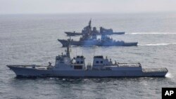 In this photo provided by South Korea Defense Ministry, destroyers from South Korea, bottom, the U.S., middle, and Japan sail during a joint missile defense drill in international waters off the east coast of Korean Peninsula, April 17, 2023. 
