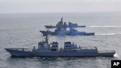 FILE - In this photo provided by South Korea Defense Ministry, destroyers from South Korea, bottom, the U.S., middle, and Japan sail during a joint missile defense drill in international waters off the east coast of Korean peninsula, April 17, 2023.