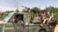 FILE - Fighters ride in the back of a pickup truck mounted with a turret in the East Nile district of greater Khartoum, in this image grab taken from handout video footage released by the Sudanese paramilitary Rapid Support Forces on April 23, 2023.