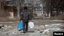 A resident walks on an empty street in the front line city of Bakhmut, Ukraine, as Russia's attack on Ukraine continues, March 3, 2023.