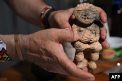 Restaurateur Gilberto Buitrago holds a ceramic piece in the Archaeological and Historical Park of Santa Maria de la Antigua del Darien, the first Spanish city founded in 1510 in mainland America, in Unguia, Colombia, on Sept. 17, 2023.