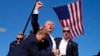 FILE - Republican presidential candidate former president Donald Trump is surrounded by U.S. Secret Service agents following an assassination attempt at a campaign rally, in Butler, Pennsylvania, July 13, 2024, in this image by AP journalist Evan Vucci.